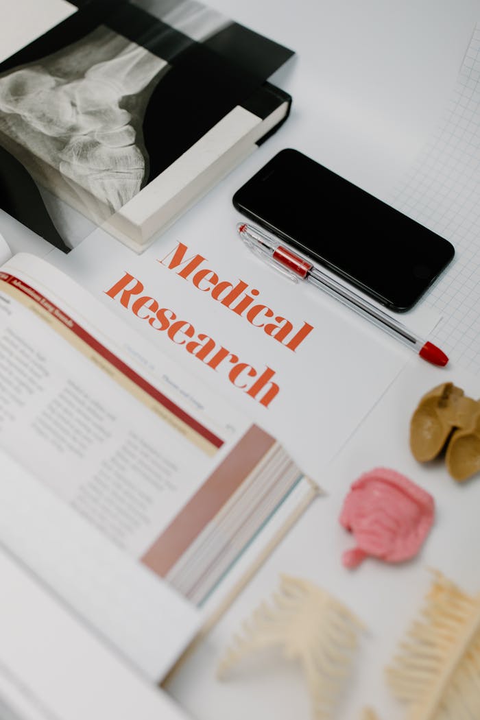 The Art of Drawing Readers In: Your attractive post title goes here Flat lay of medical research materials with books and anatomical models.